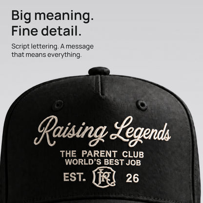 Close detail of ivory Raising Legends script embroidered on black cotton twill. Big meaning. Fine detail.