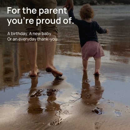 A father and child hold hands at the water’s edge. For the parent you’re proud of. A birthday, a new baby, or an everyday thank-you.